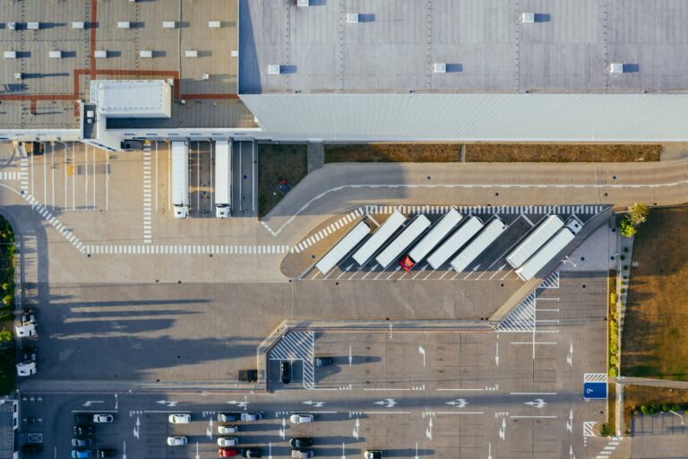 Overhead view of the outside of a warehouse with trucks